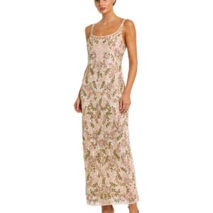 A woman stands against a plain white background, wearing the Embellished Bow Belt Illusion Long Sleeve A Line Dress adorned with floral patterns.