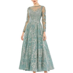 A woman in an Embellished Bow Belt Illusion Long Sleeve A Line Dress with teal embroidery stands against a white background.