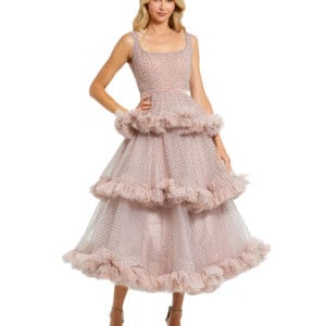 A woman in a Sleeveless Dot Net Ruffle Dress poses against a white backdrop.