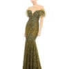 A person stands against a white background wearing a Green Feathered Crystal Embellished Sleeveless Gown.