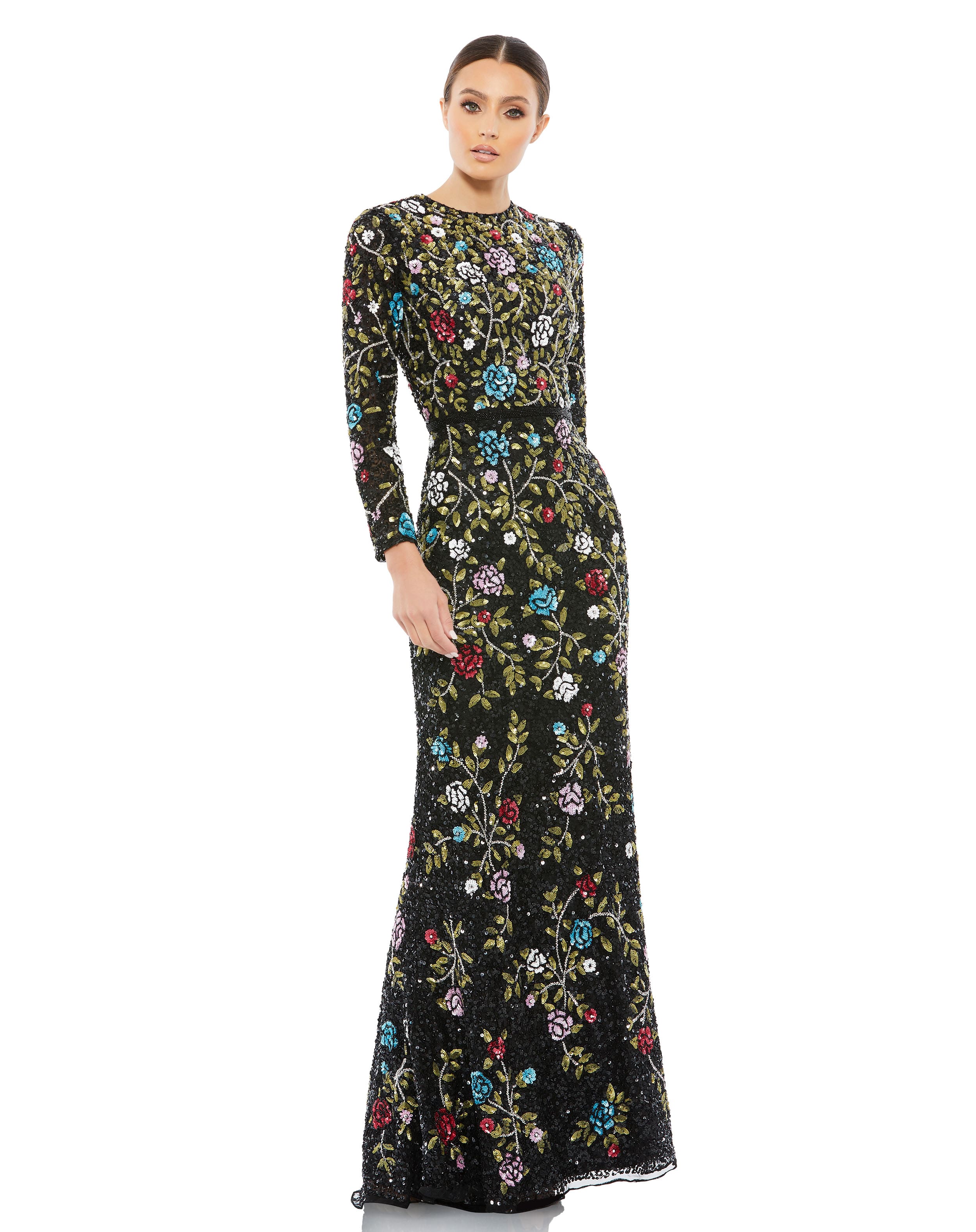 A person in the Floral Embellished Long Sleeve Gown poses against a plain white background, showcasing its form-fitting design and colorful floral embroidery.